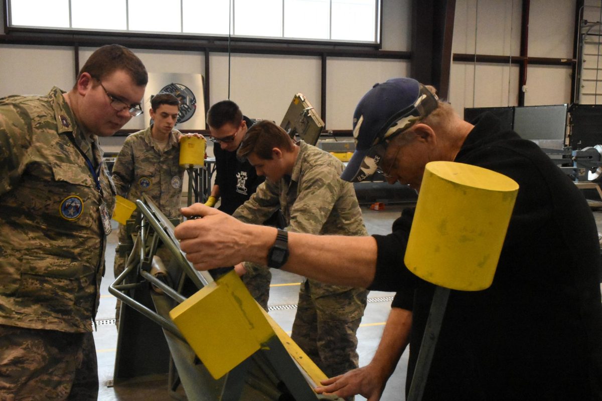 Cadets in Airframe work on a model.