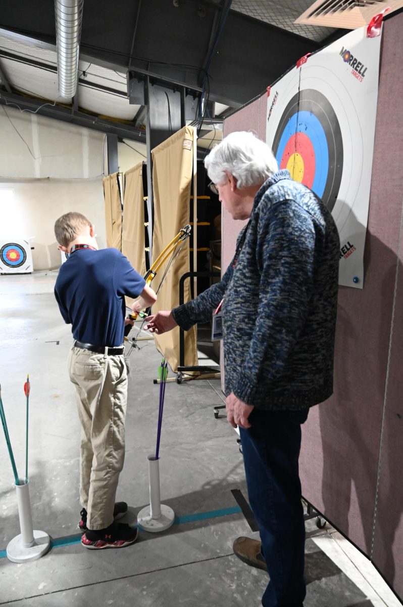 Coach Sage instructs a cadet on the proper method to place an arrow on the bow. 