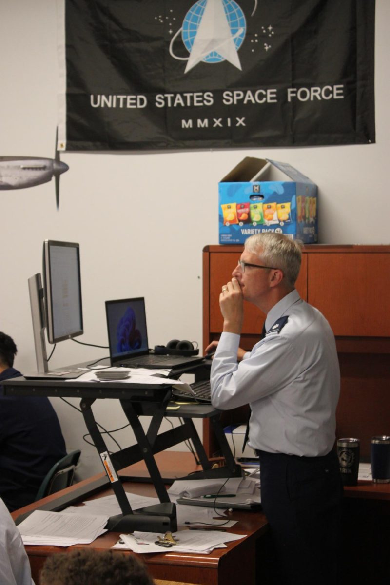 Lt. Col. Erik Tisher eyes the Canvas page he is working on for his cadets. Lt. Col. Tisher is the new JROTC SASI.