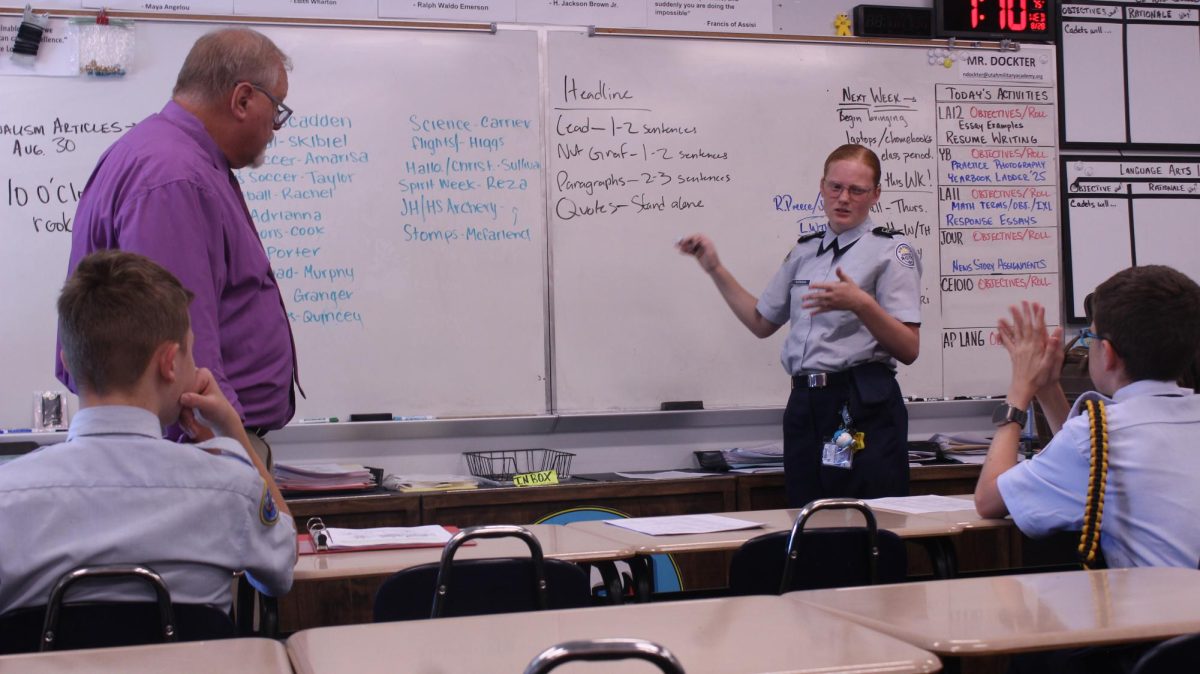 Mr. Dockter watches as Journalism Editor-In-Chief, Alexus Workman reviews the format of an article.