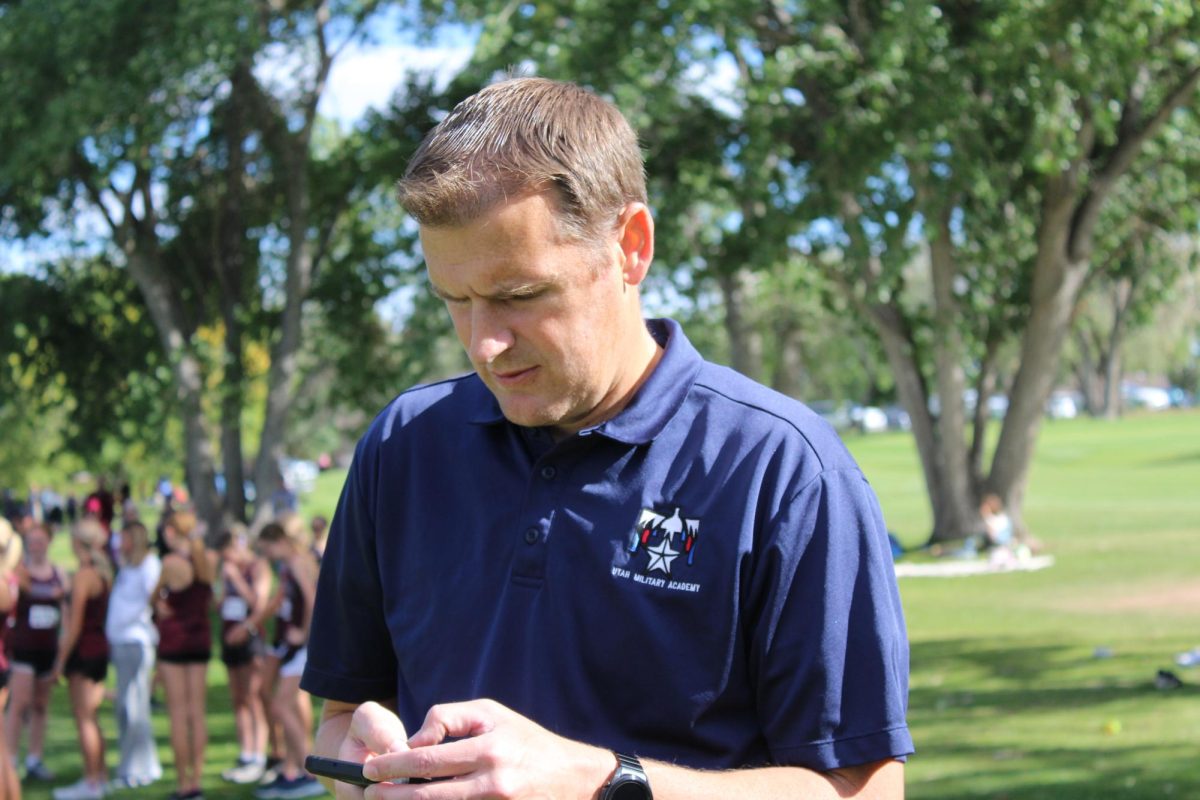 Coach Jeff Bodell looks at the results of his runner's performances. 