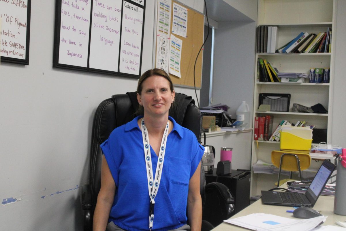 Mrs. schleglemilch is sitting at her desk.